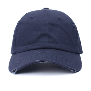 Detail of distressed navy blue cotton baseball cap showing frayed holes and fringe brim