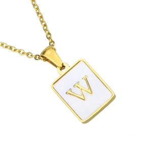 Close-up of golden square shell pendant necklace with letter W and fine O-chain