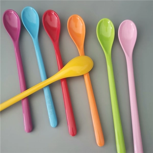Set of seven colorful long-handle thickened plastic dessert spoons on grey background