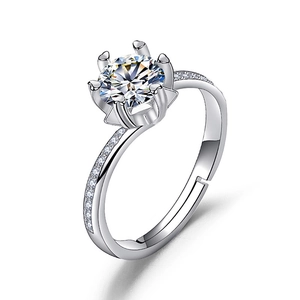 Macro detail of six-prong moissanite ring with side stones and adjustable silver band