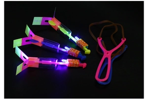 Macro shot of 3-piece LED slingshot arrow set with elastic launchers and glowing lights