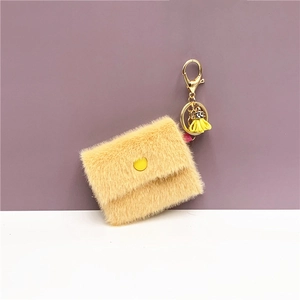 Detail of plush envelope mini coin pouch with gold keychain and yellow tassel decor