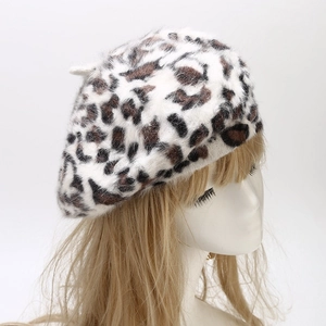 Detailed side view of leopard print faux rabbit fur beret with soft plush texture