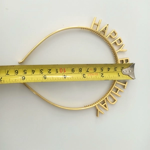 Close-up of gold Happy Birthday headband with tape measure showing 12cm diameter