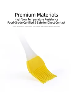 Detail of yellow silicone basting brush with heat resistant bristles and translucent handle