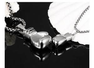 Macro detail of solid silver boxing glove pendants in punk style made of titanium steel