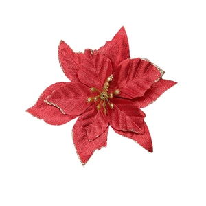 Detail of red Christmas poinsettia flower with golden glitter edges and stamen