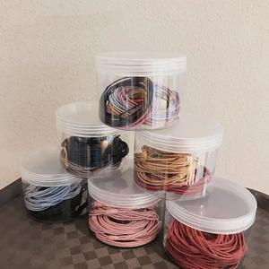 Set di barattoli trasparenti con elastici per capelli colorati in tonalità Morandi
