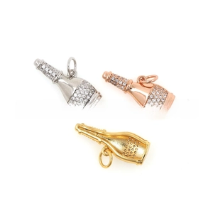Detailed macro view of 18k gold-plated champagne bottle pendants with micro-pave zircons