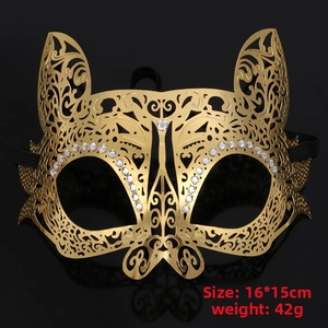 Close-up of golden laser-cut metal masquerade mask with sparkling rhinestones and elastic strap