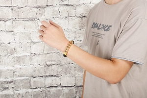 Men's fashion bracelet featuring golden bicycle chain design and black leather band