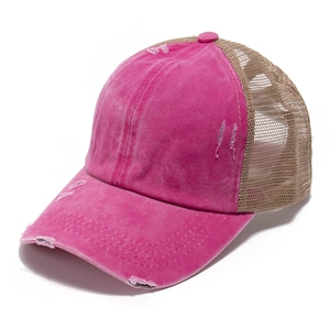 Detail of distressed pink and khaki mesh baseball cap showing washed vintage texture