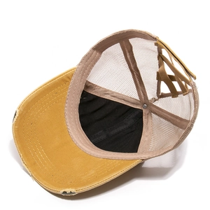 Mustard yellow vintage baseball cap with ponytail opening and distressed brim detail