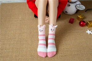 Close-up of pink striped coral fleece socks with cute cartoon pig 3D ears detail