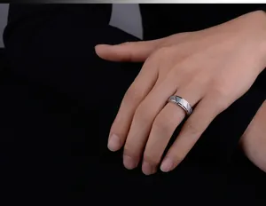 Detail of a wide brushed stainless steel ring with geometric diamond pattern for men