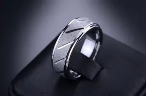 Macro view of men's matte 316L stainless steel ring with diagonal textured grooves