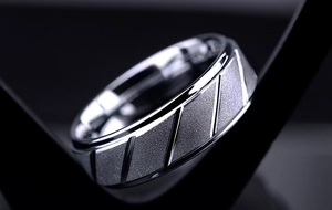 Detailed view of silver men's ring with brushed matte finish and diagonal engraved texture