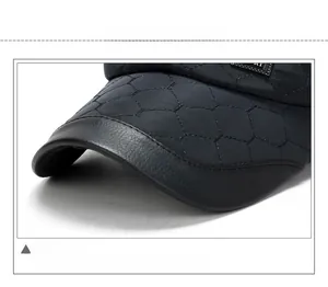 Close-up of quilted pattern and leather-edged brim on a men's winter baseball cap