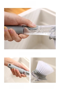 Detail of soap dispensing kitchen brush with comfortable handle and sturdy bristles