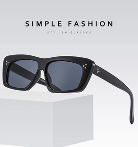Detail of silver triple rivets on black thick frame rectangular sunglasses with dark lenses