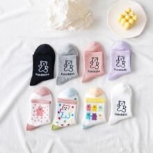 Detailed flat lay of eight pairs of Japanese style embroidered cotton socks in candy colors