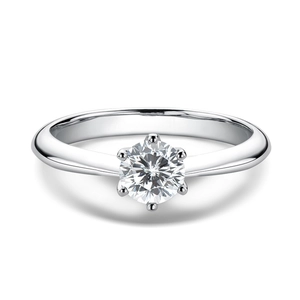 Detailed close-up of a classic six-prong silver engagement ring with a brilliant round cut stone