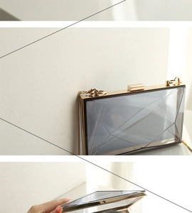 Macro view of geometric acrylic clutch with golden metal frame and chain strap