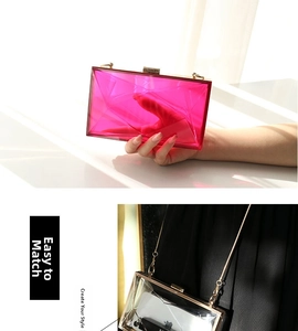 Detail of geometric acrylic evening clutch with gold chain strap and crystal texture