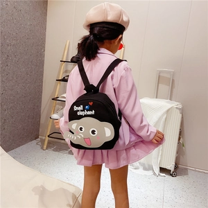 Detailed view of child wearing black canvas backpack with a cute 3D grey elephant