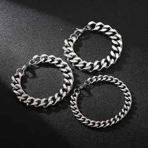 Three silver stainless steel Cuban link bracelets in various thickness on black background