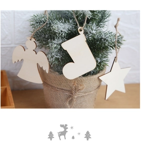Close-up of wooden angel star and sock Christmas ornaments hanging on a snowy tree
