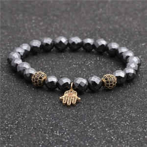 Faceted hematite beaded bracelet with golden Hamsa Hand pendant and micro-pave charms