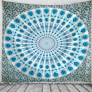 Detail of blue and green mandala tapestry hanging on white brick wall with floral borders
