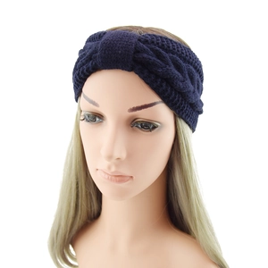 Detailed knit texture of dark blue twist knot headband on a model mannequin head