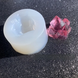 Detail view of translucent silicone mold and finished pink resin crystal stone geode