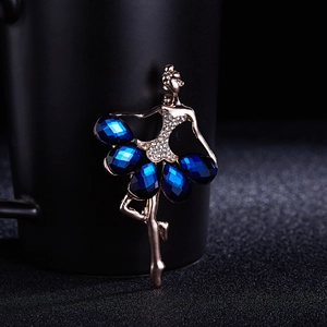 Macro detail of dancing girl brooch with navy blue crystals and gold-tone metal frame