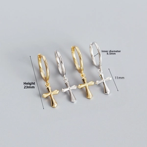 Detail view of gold and silver S925 sterling silver cross charm hoop earrings with dimensions