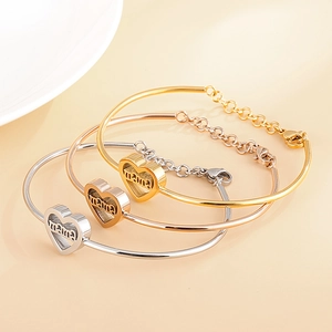 Three-piece set of polished heart Mama bracelets in gold, rose gold, and silver finishes