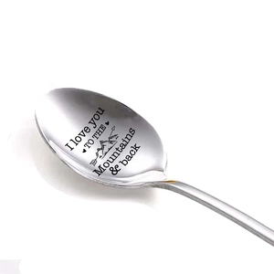 Macro shot of 410 stainless steel spoon with Mountains and Back engraved message