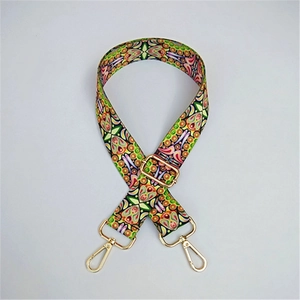 Close-up of adjustable colorful ethnic pattern bag strap with gold metal lobster clasps