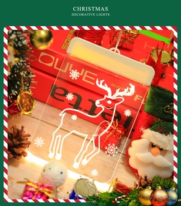 Detail of reindeer and snowflake LED suction cup light with warm white Christmas glow