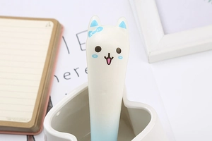 Close-up of a blue and white squishy stress relief pen with cartoon bow design