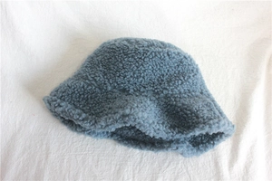 Detailed texture of blue plush lamb wool fisherman hat with soft thick thermal material