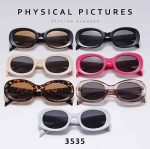 Flat lay of retro oval sunglasses in 7 colors including leopard print and white frames