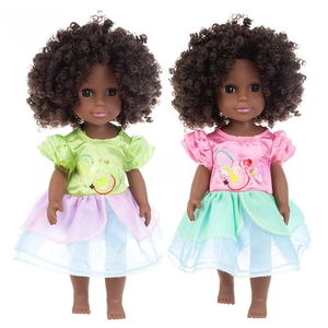Detail of 14-inch black vinyl dolls with afro hair in colorful layered mesh skirts