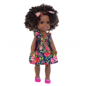 Close-up of a 14-inch Black girl doll wearing a floral blue dress and red shoes