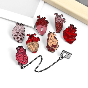 Cartoon anatomical heart enamel pin set with gothic artistic designs on white background