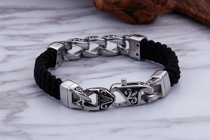 Detail of men's geometric steel totem bracelet with double-layered nylon rope and clasp