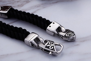 Macro detail of engraved steel buckle on double-layer braided nylon rope bracelet