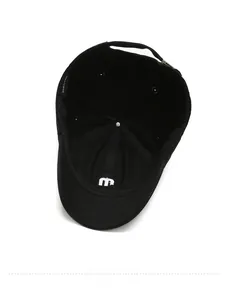 Detail view of the black cotton baseball cap interior with embroidered M logo and metal clasp